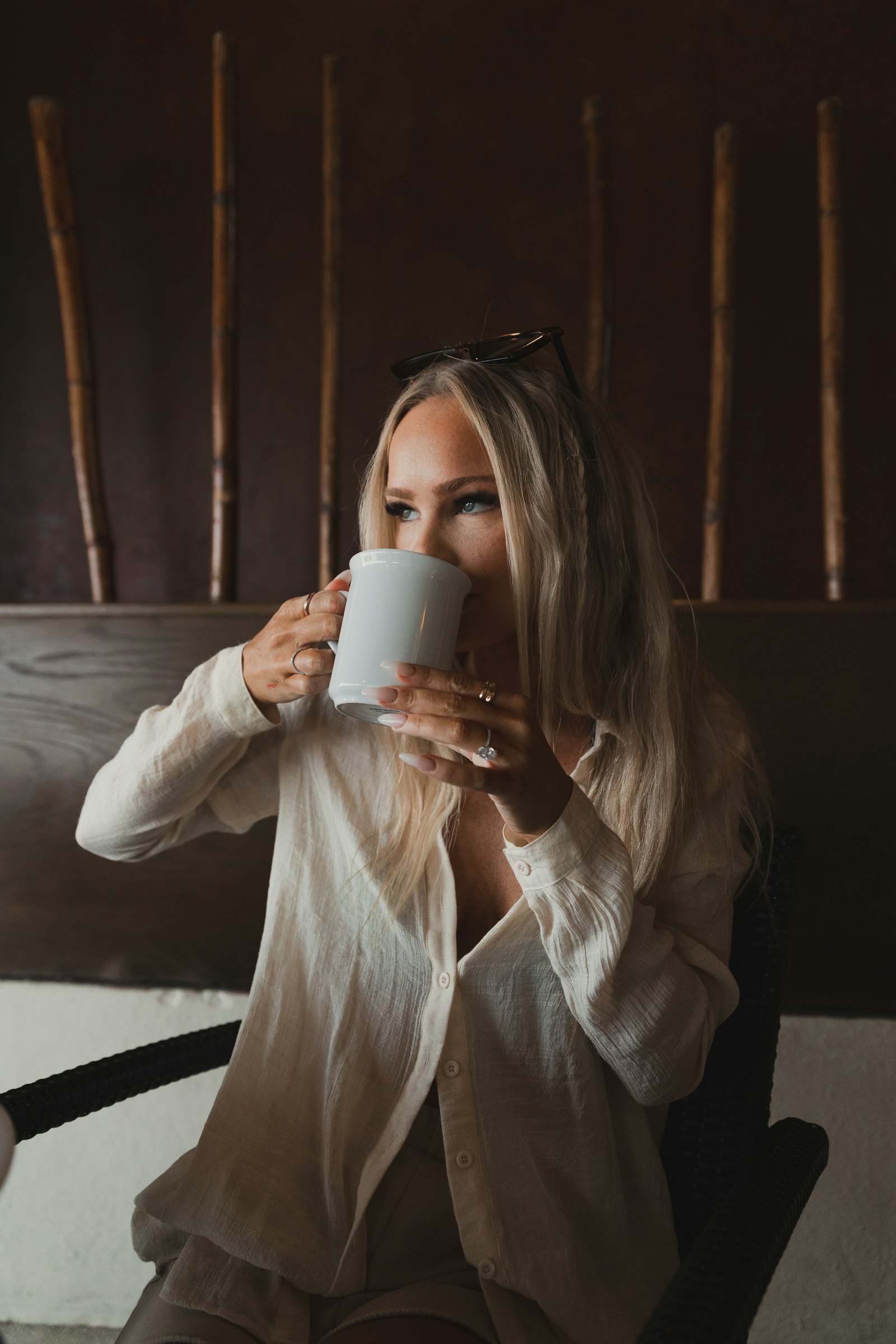 Woman sipping from a mug at home