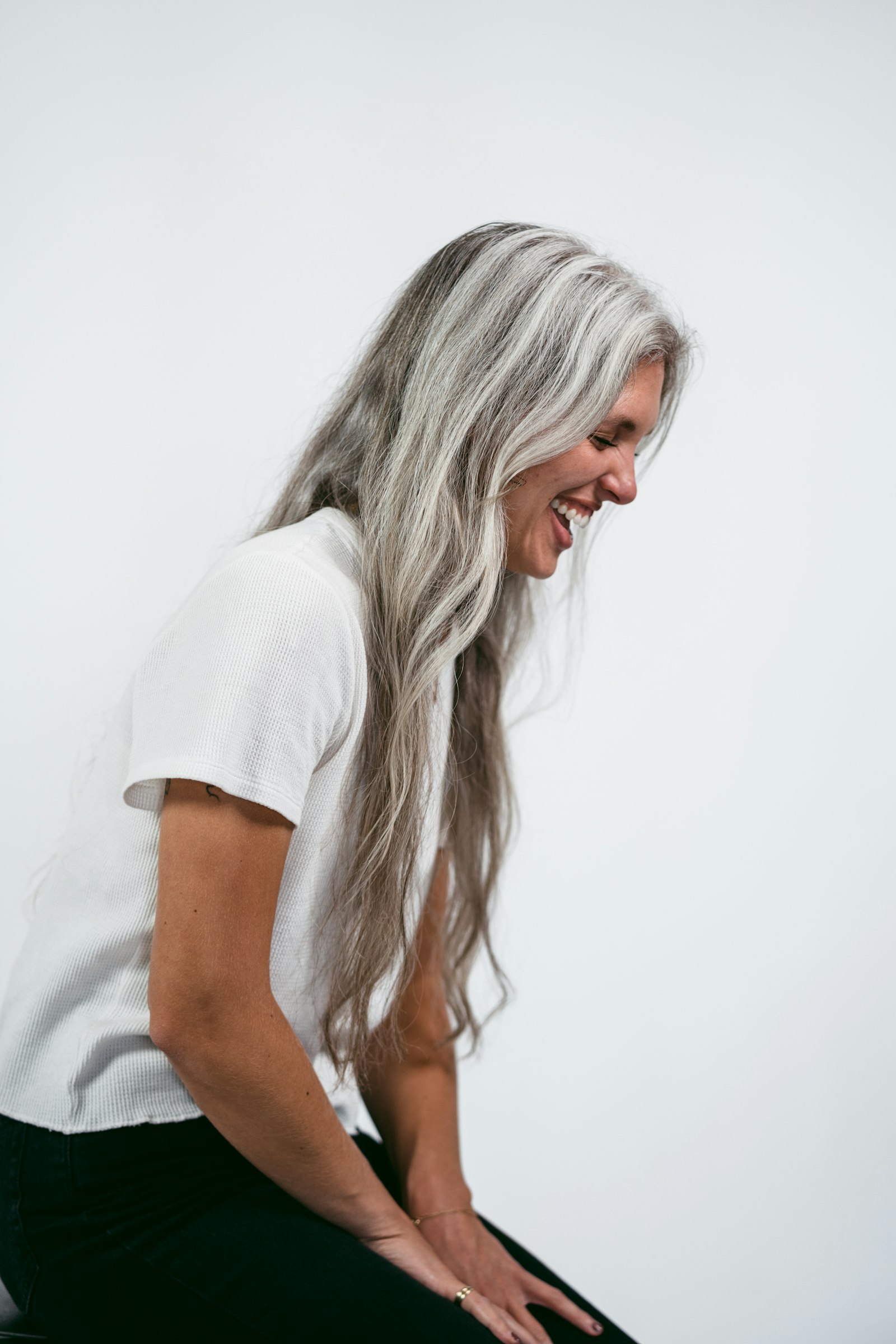Woman with long silver hair laughing